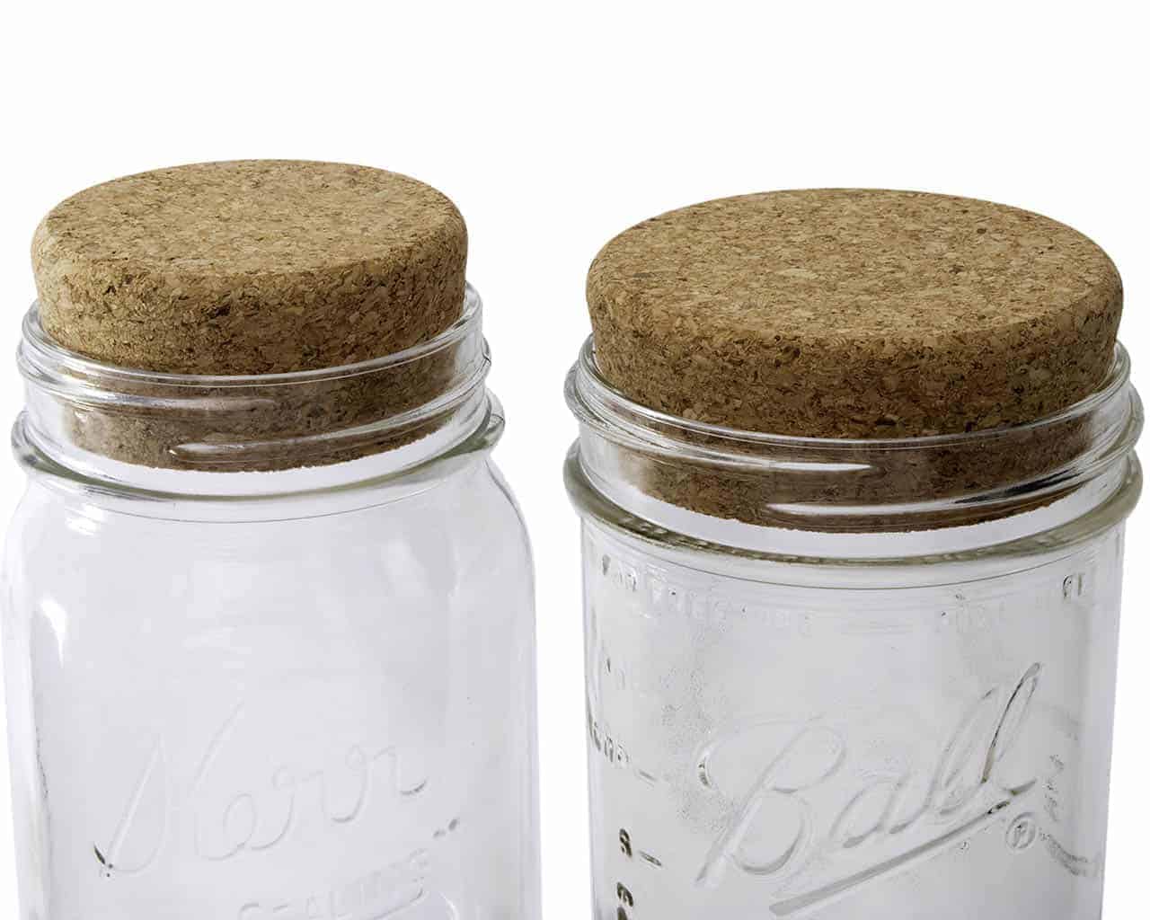 Four Mason Jar Lifestyle cork lids for regular-mouth Mason jars, used as stoppers or lids for preserving and storage.