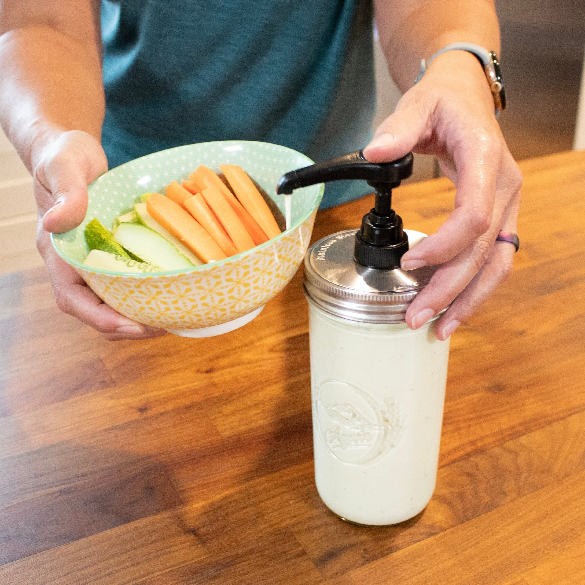 Food grade dispenser pump attached to a matte stainless steel lid on a regular-mouth Mason Jar for liquid or condiment dispensing.