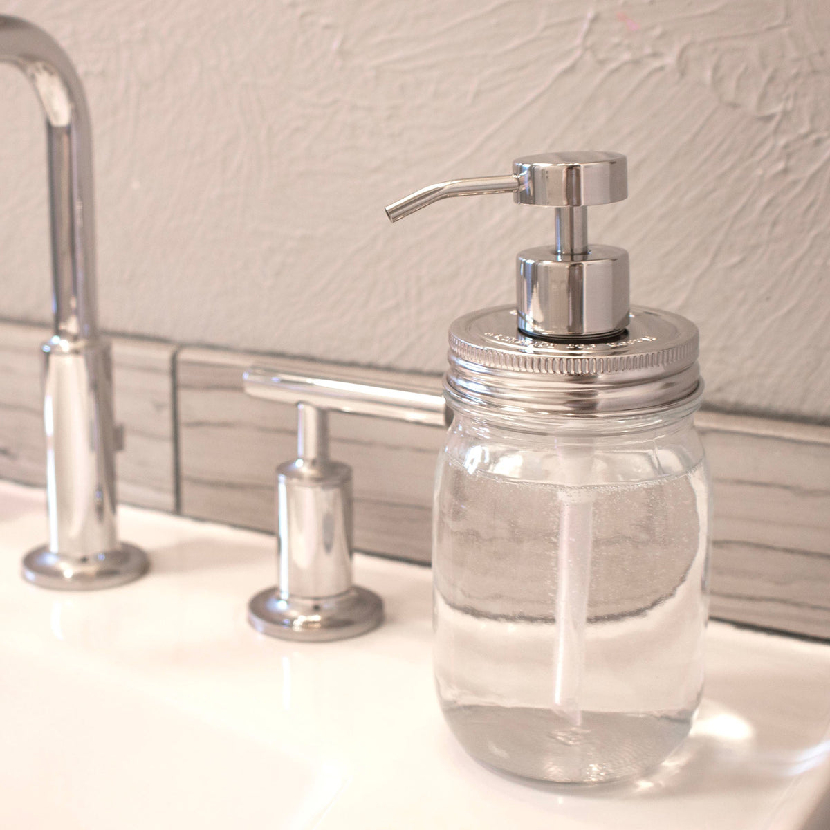 Chrome soap pump dispenser with mirror finish attached to a Mason Jar Lifestyle regular mouth mason jar for soap or lotion.