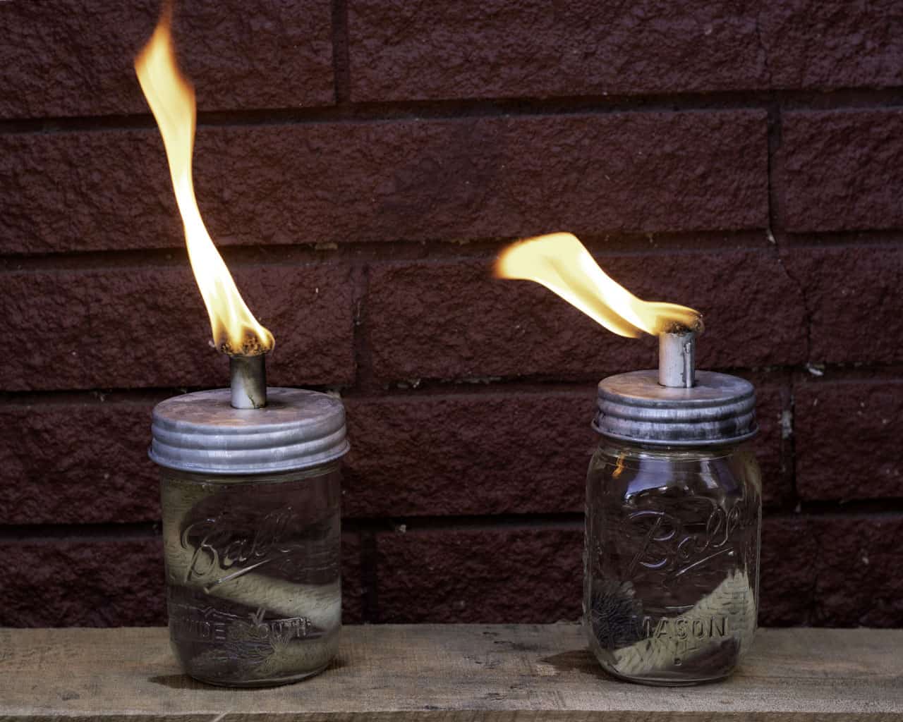 Galvanized metal lid for Mason Jar Lifestyle Tiki Torch Oil Lamp on a mason jar, designed for regular-mouth jars.