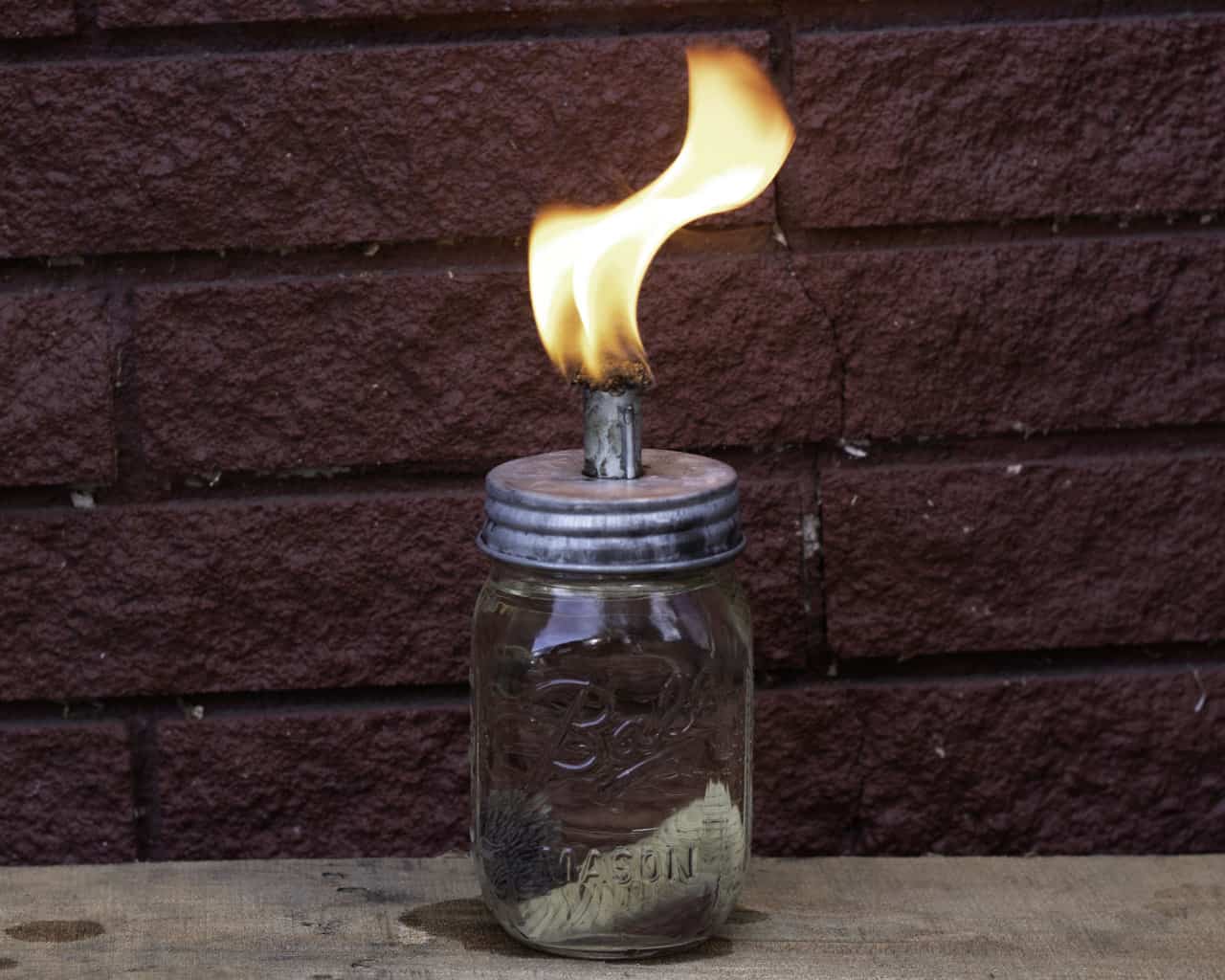 Galvanized metal lid for Mason Jar Lifestyle tiki torch oil lamp, designed for regular-mouth mason jars, with a rustic metal finish.