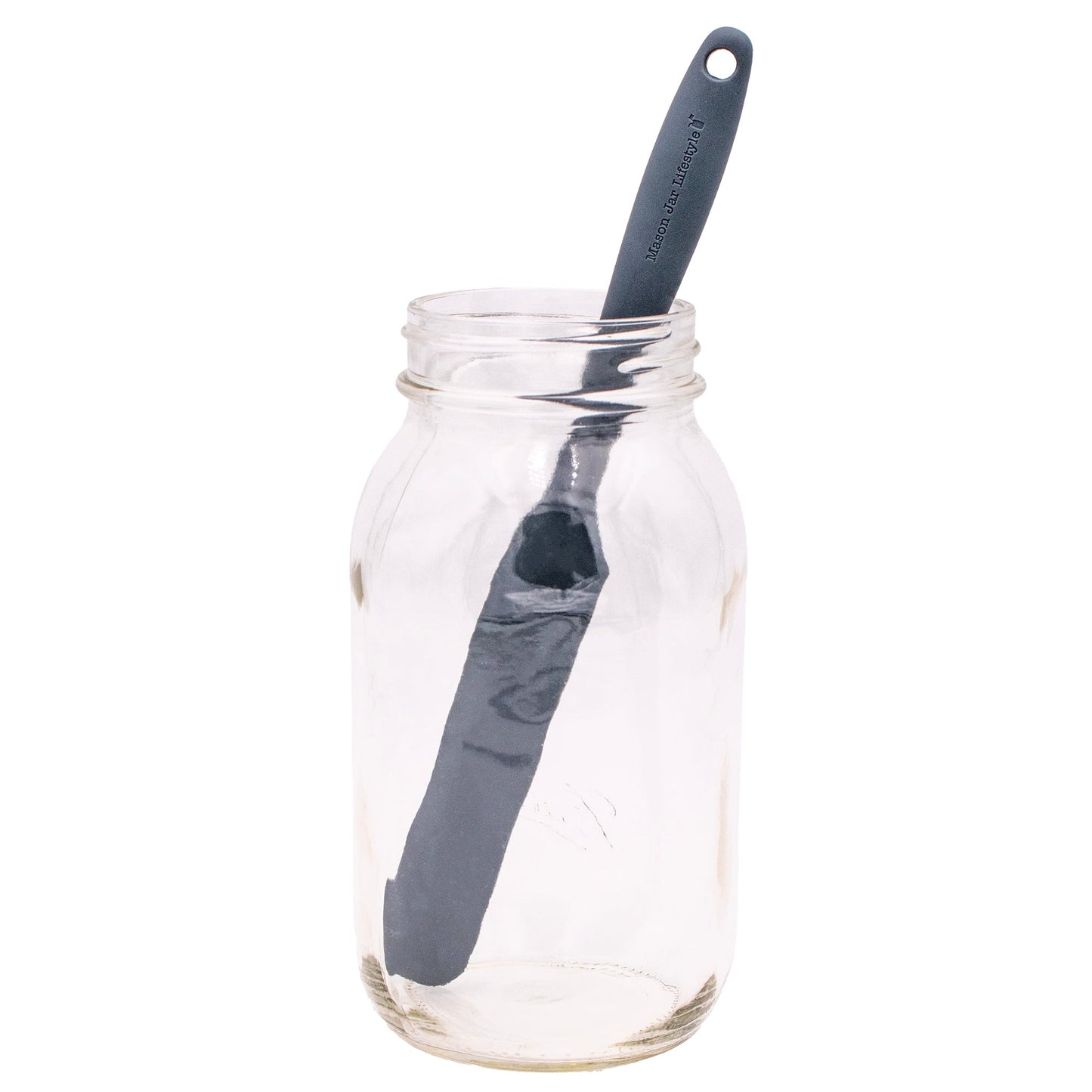 Gray silicone jar scraper from Mason Jar Lifestyle with a peanut butter and sourdough bread in the background.