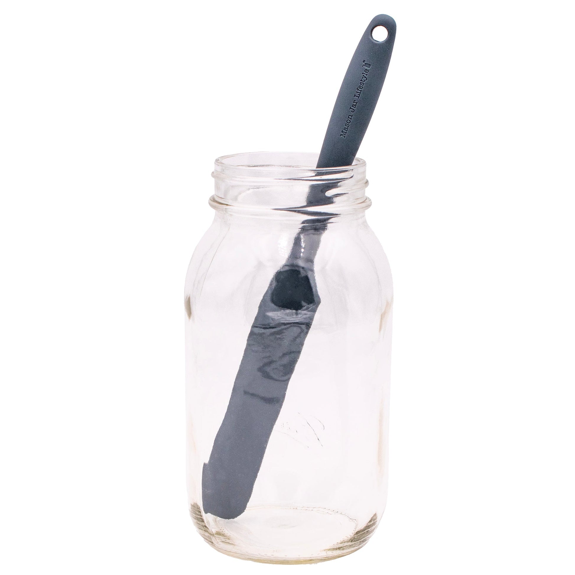 Gray silicone jar scraper from Mason Jar Lifestyle with a peanut butter and sourdough bread in the background.
