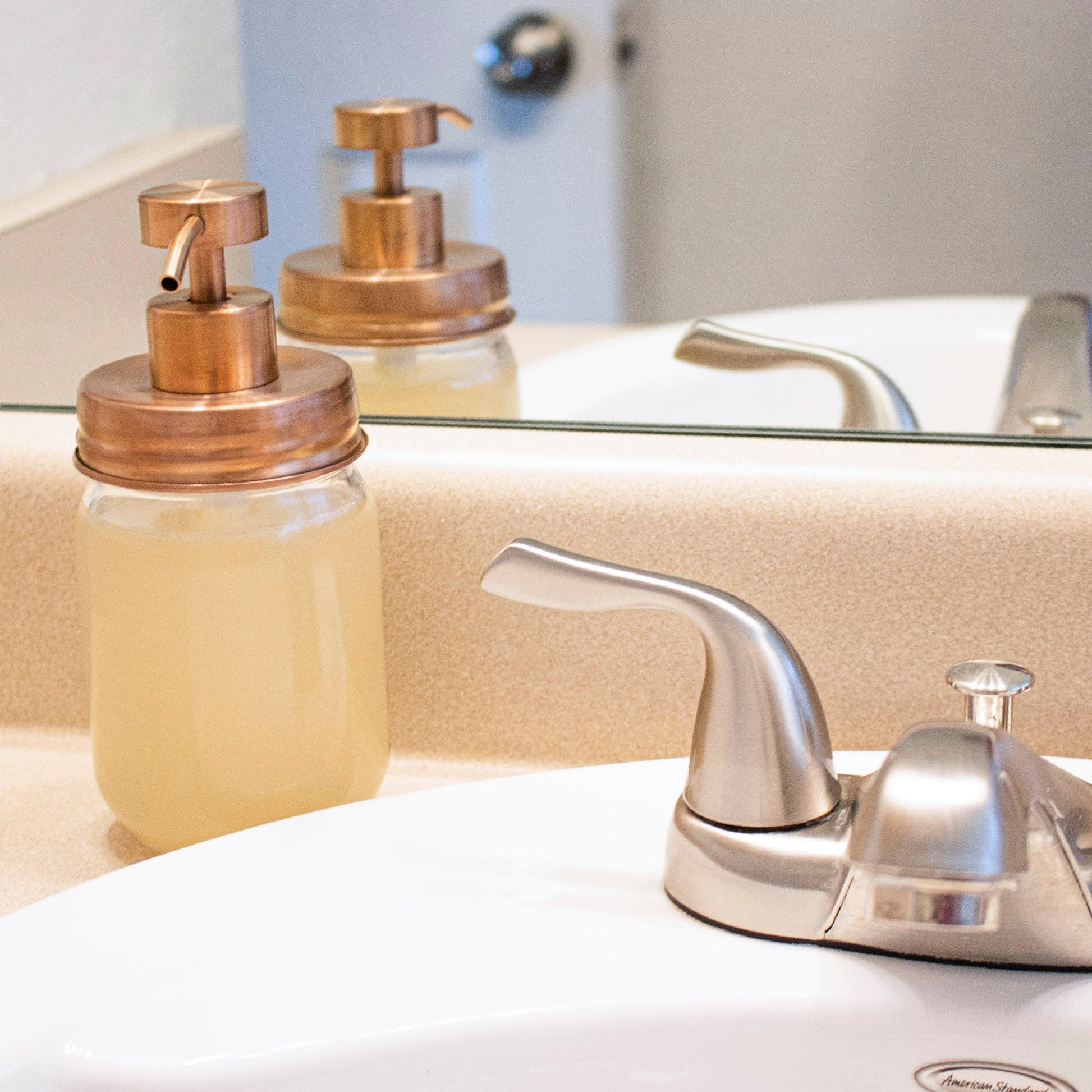 Rose gold soap pump lid kit for regular mouth Mason jars, perfect for bathroom or kitchen soap dispensers, reusable and stylish.