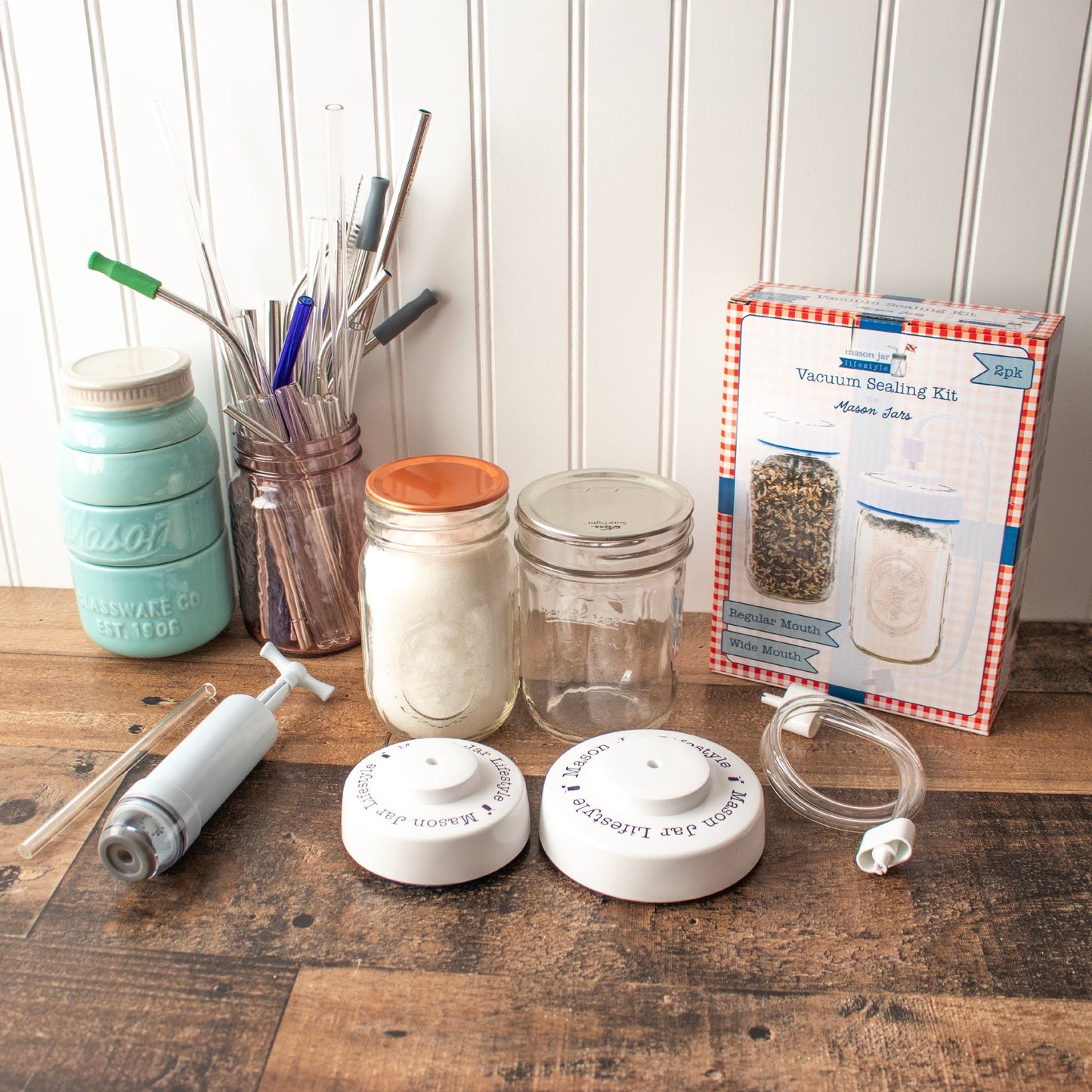 Mason Jar Lifestyle vacuum sealing kit with hand pump for regular and wide mouth mason jars, showing sealing accessories and jars.