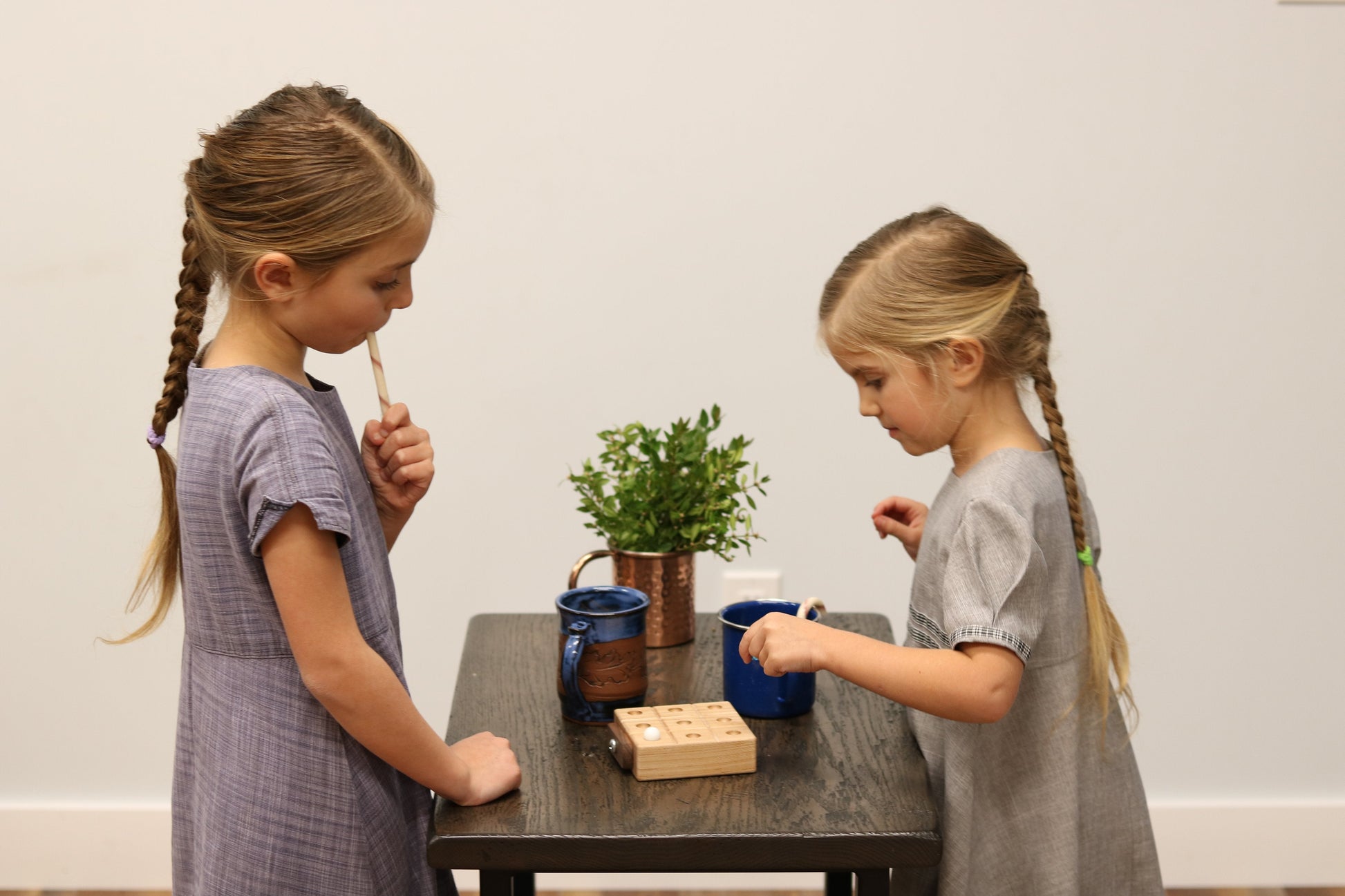 Wooden Tic Tac Toe game with marbles, featuring built-in storage, crafted by AmishToyBox.com in natural wood finish.