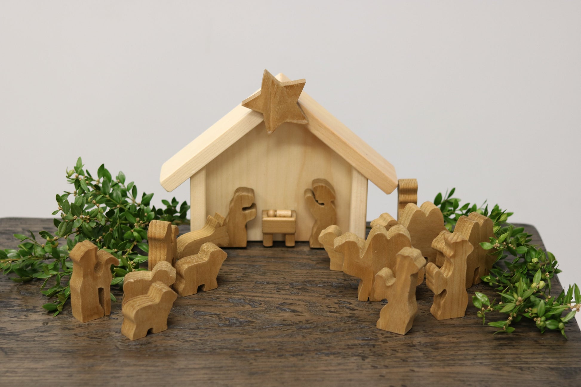 Wooden Nativity manger scene set with 14 pieces from AmishToyBox.com, featuring detailed handcrafted wooden figures for holiday decor.