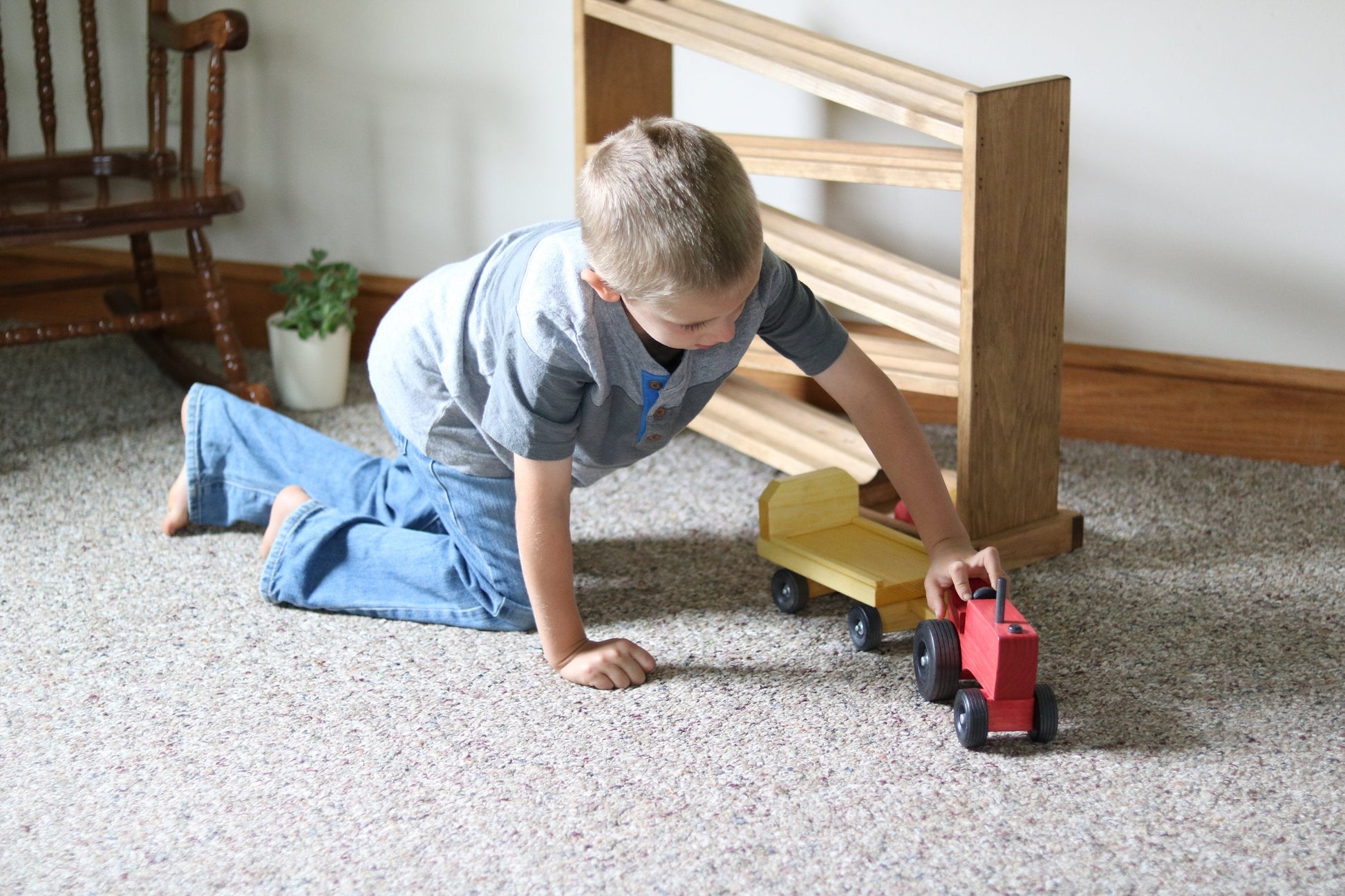Amish-made wooden toy tractor and wagon set with hay bales, featuring colorful wooden construction and detailed farm scene.