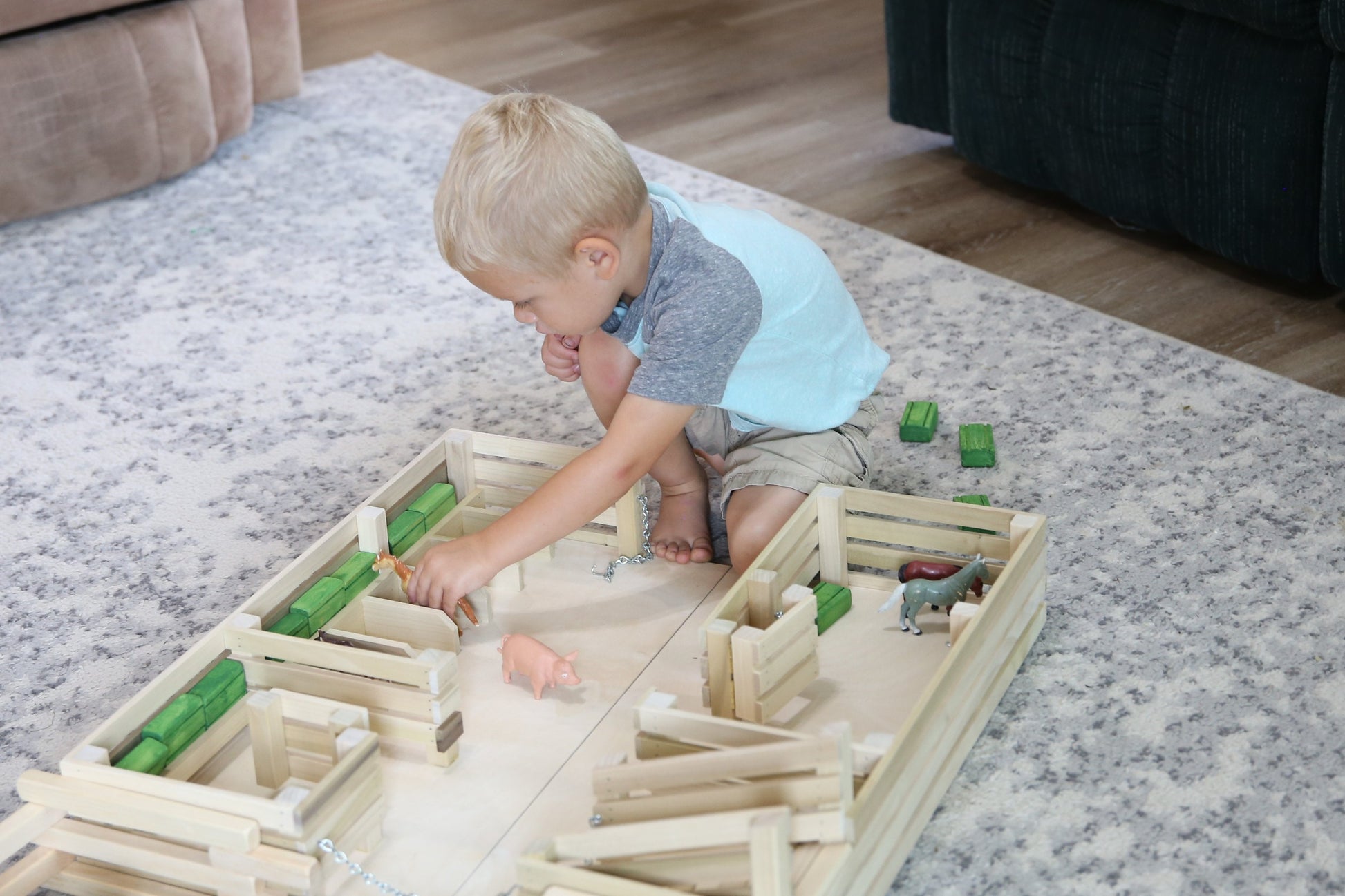Amish-made unfinished wooden folding stock yard farm toy with detailed farm scene and toy animals on a wooden base.