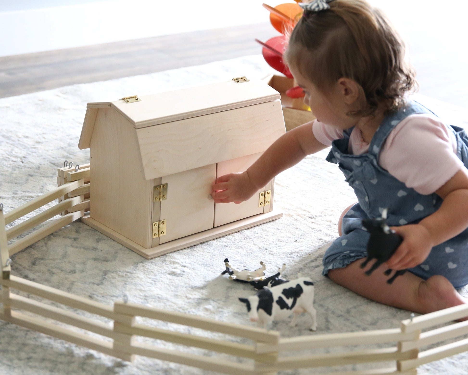 Amish-made Mini Wooden Barn Toy with a hip roof, featuring detailed wooden construction and a rustic, natural finish.