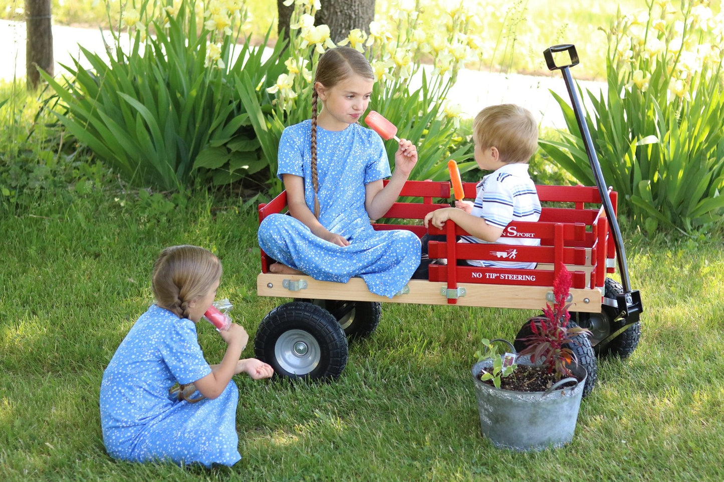 Amish-made Berlin Flyer Sport Wagon Model F410, a sturdy children's scooter and wagon with a wooden frame and colorful design.
