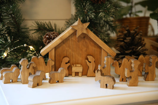 Wooden Nativity manger scene set by AmishToyBox.com with 14 handcrafted wooden toy figures and stable background.