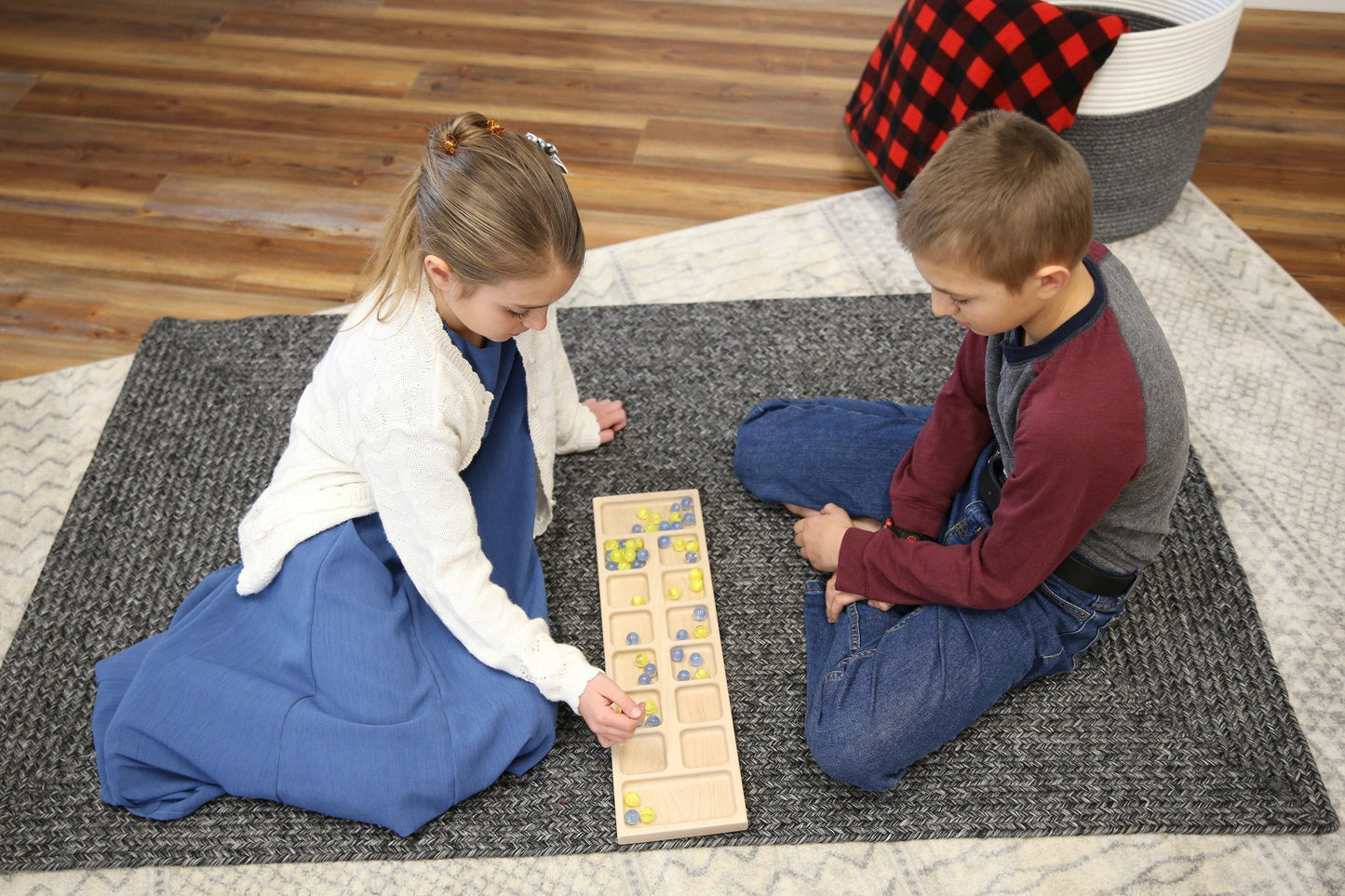 Amish-made solid oak wood Mancala board game set with colorful marbles on a smooth wooden surface, designed for family fun.
