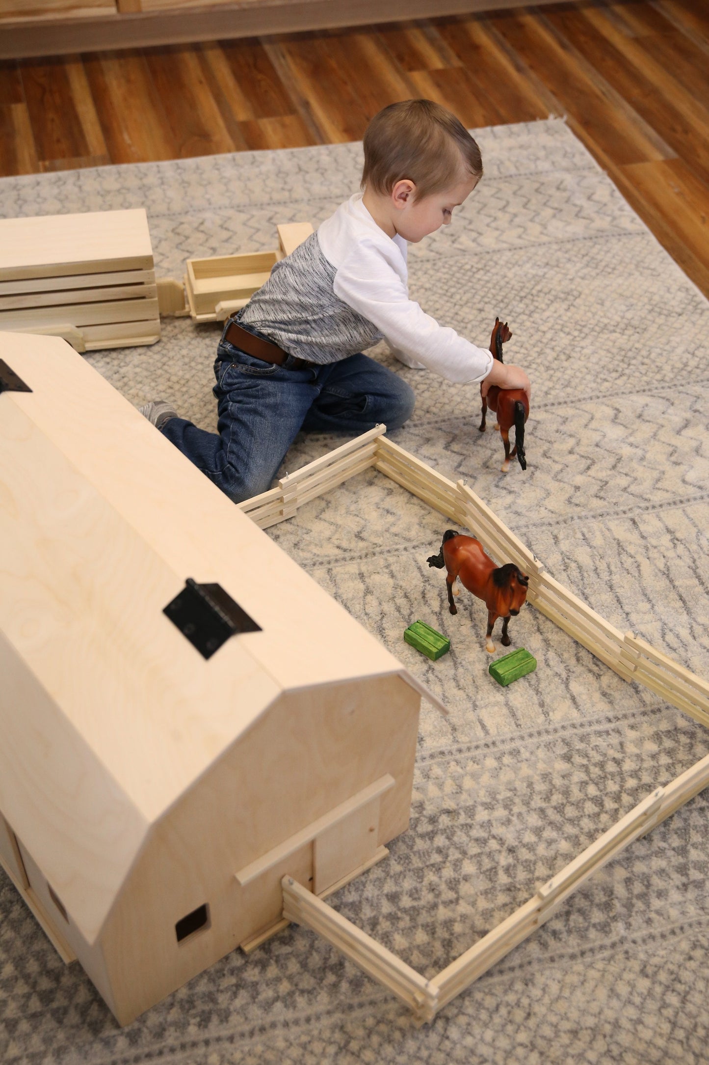 Unfinished large wooden Amish-made hip-roof barn toy with detailed farm features, perfect for imaginative wooden farming play.