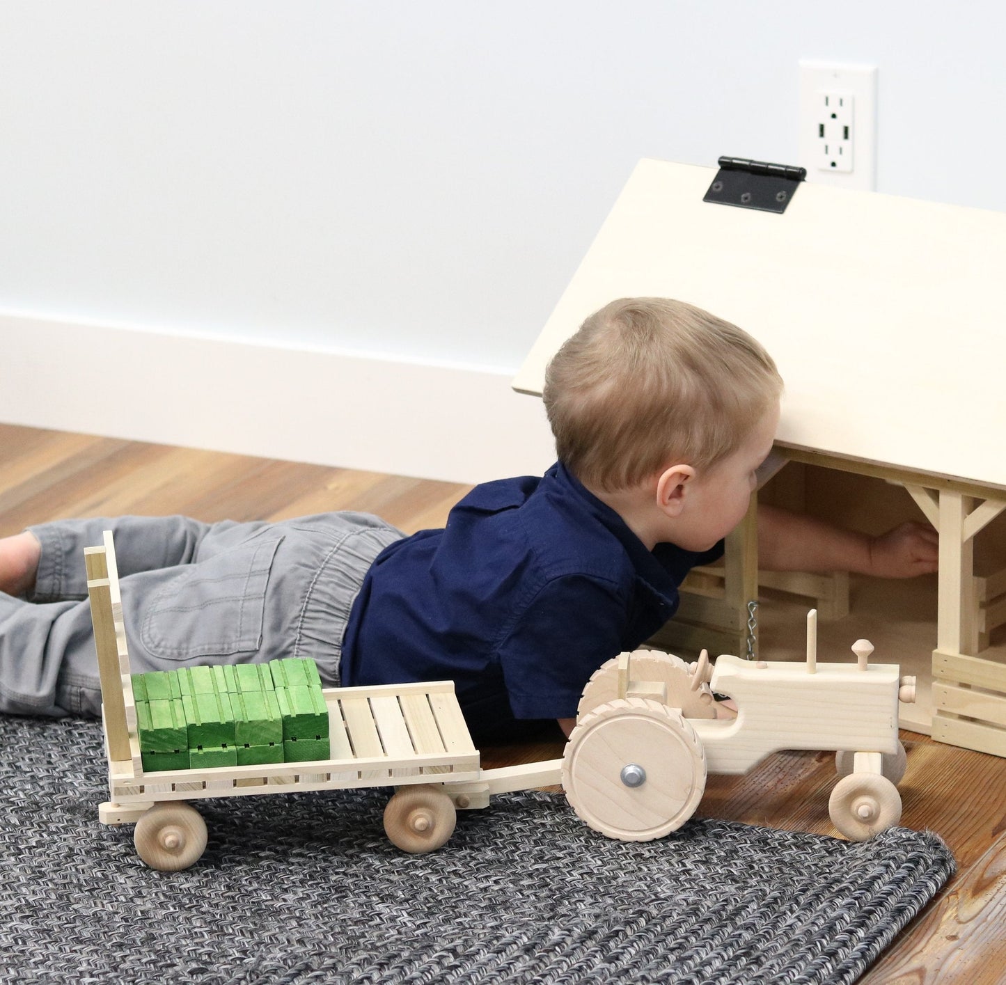 Amish-made wooden toy tractor with hay wagon and hay bales, perfect for children’s imaginative play and farm-themed fun.