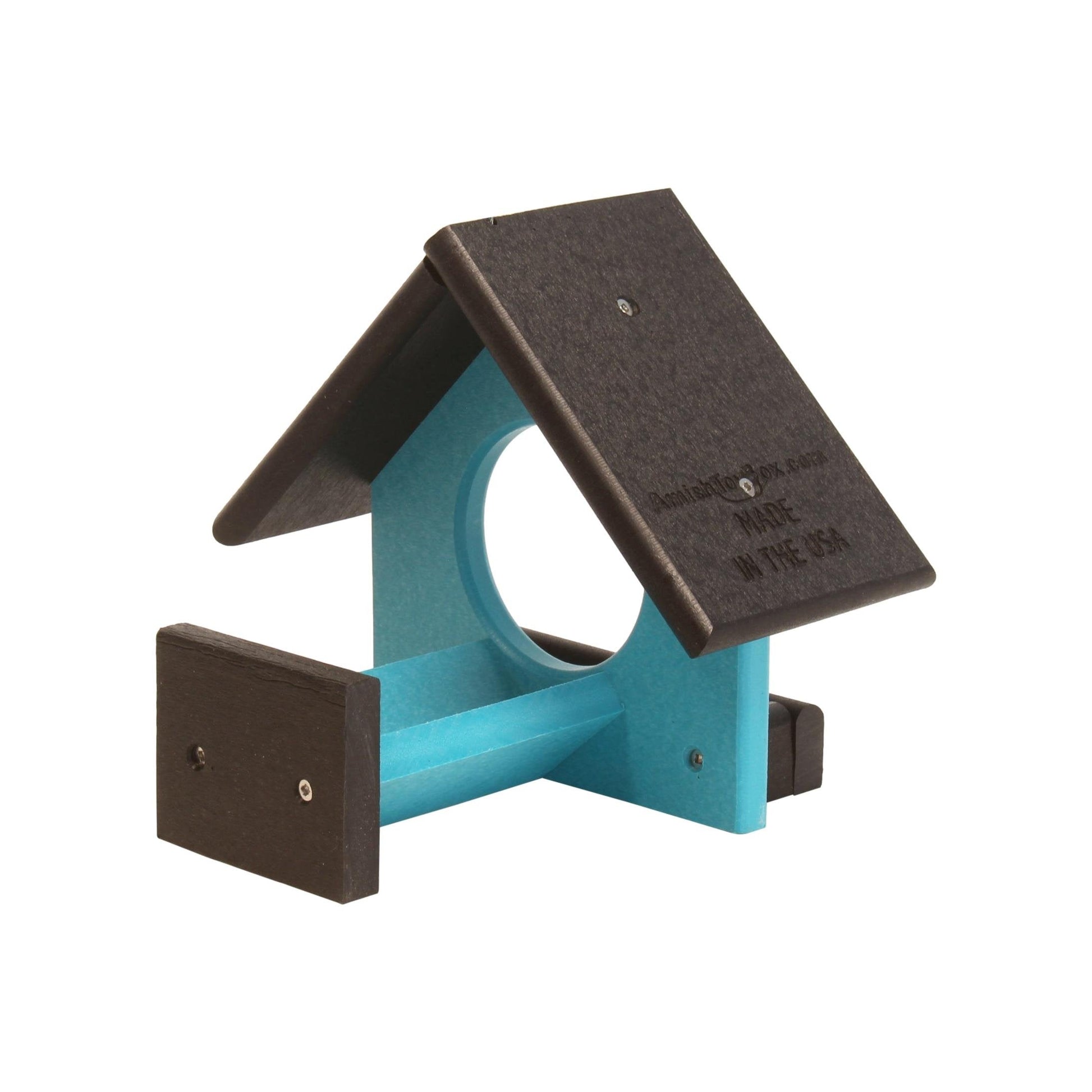 Amish-made peanut butter bird feeder designed to fit an 18 oz. jar, shown mounted outdoors with birdseed and surrounding greenery.