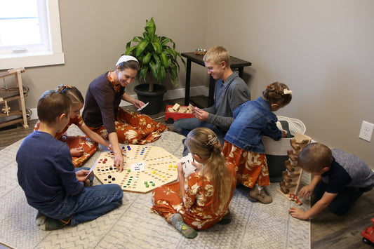 Travel marble chase board game set with a 23-inch double-sided wooden board, featuring colorful marbles and game pieces.