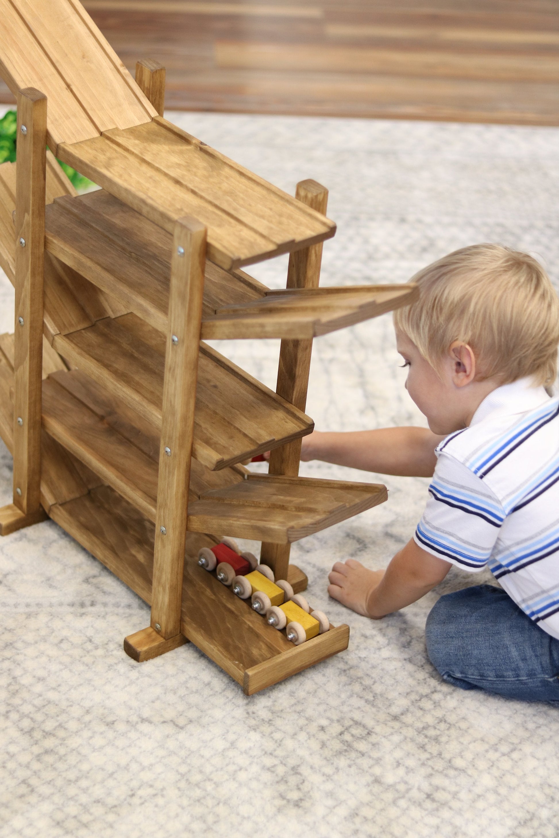 Amish-made handcrafted wooden marble and ball roller racetrack toy from AmishToyBox.com, featuring colorful wooden car rollers and track.