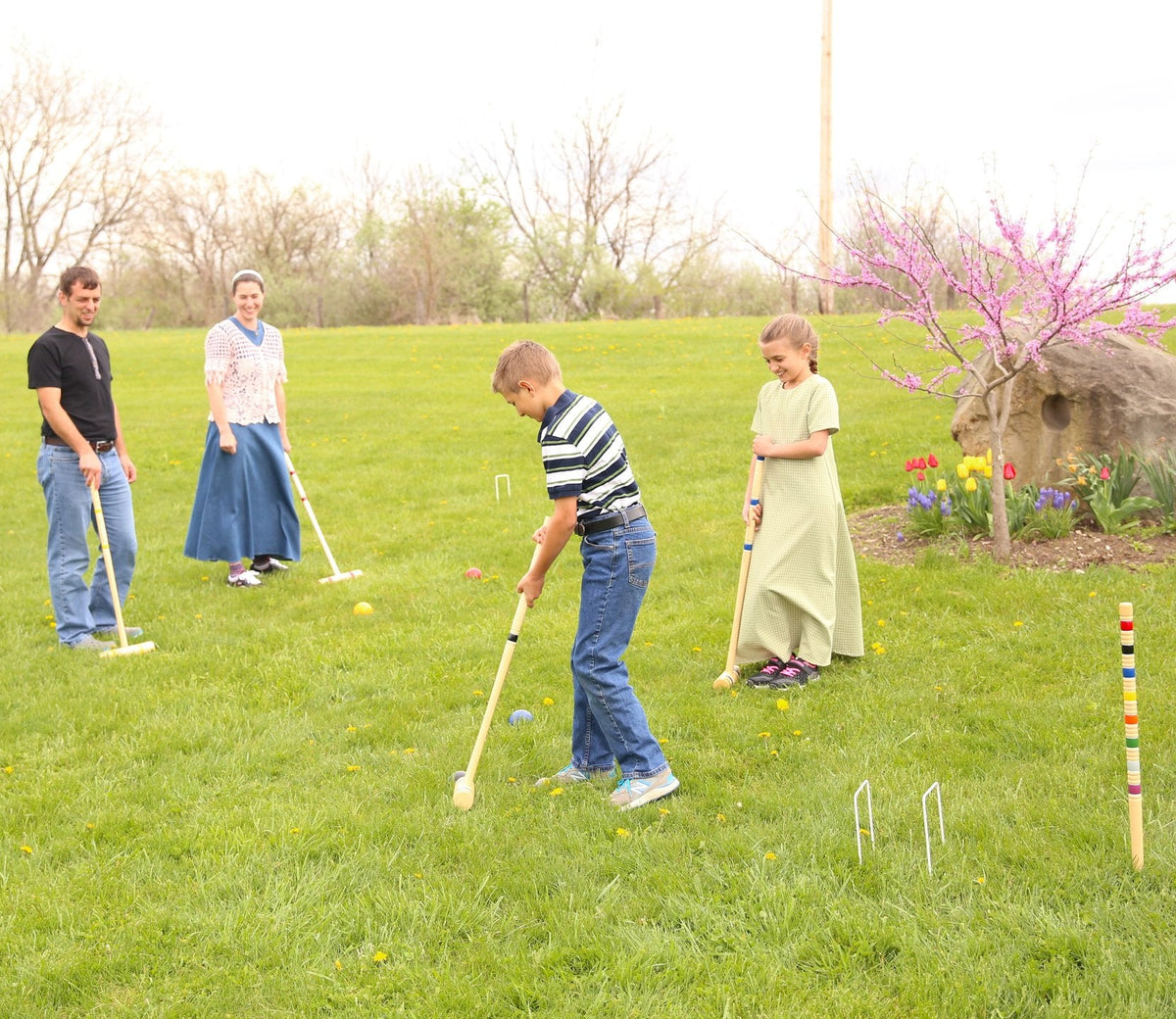 Amish-made Deluxe Croquet Game Set with six mallets, balls, wickets, and wooden holder, perfect for outdoor family play.
