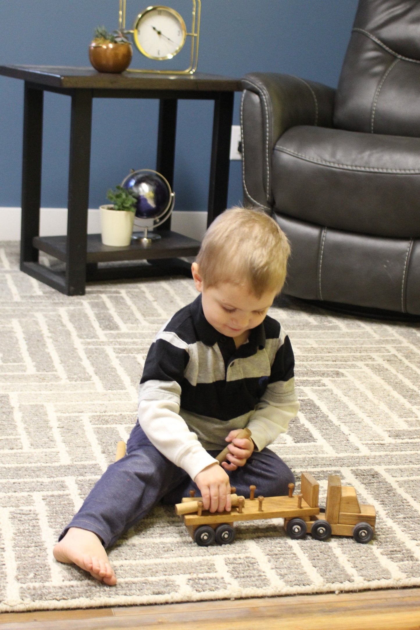 Amish-made wooden log semi truck toy with removable logs, perfect for wooden train and truck toy collections.
