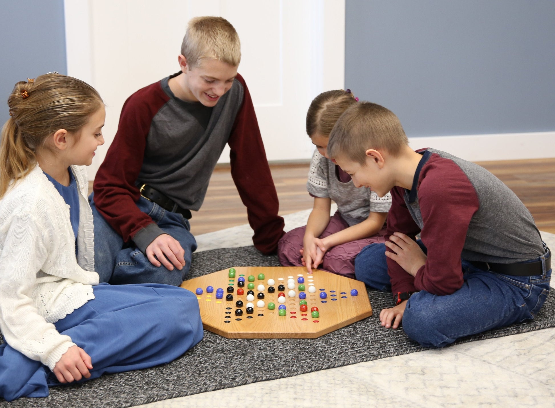 Medium-sized AmishToyBox.com hand-painted oak Chinese checkers board game with colorful game pieces on a 19-inch wooden surface.