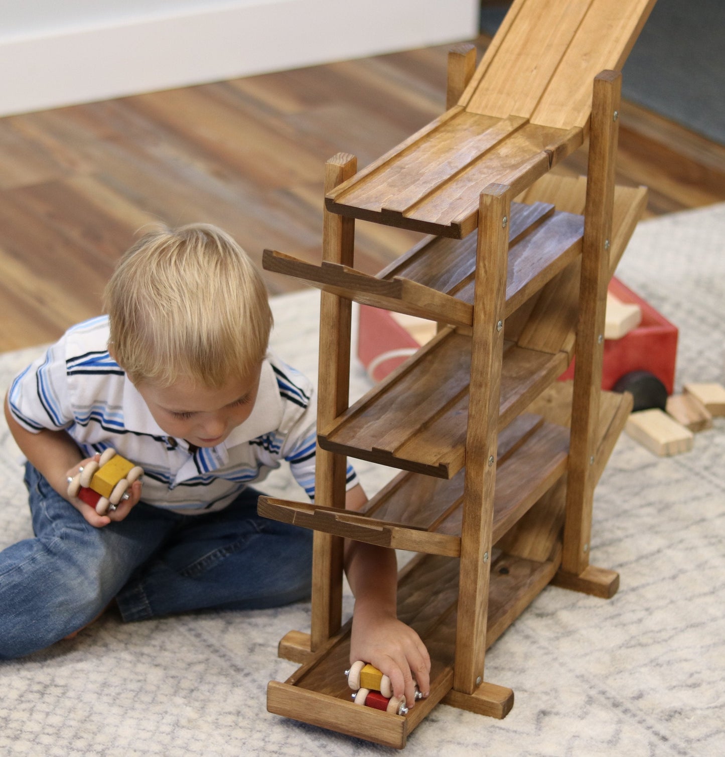 Amish-made handcrafted wooden marble and ball roller racetrack toy with colorful wooden car rollers on a smooth wooden track.