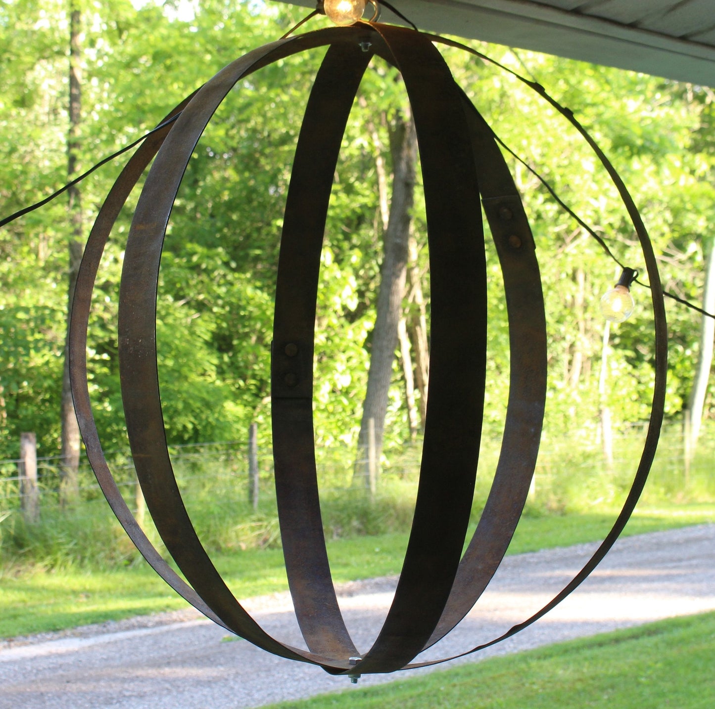 Rustic hanging plant holder made from reclaimed whiskey barrel rings, suitable for outdoor use, by AmishToyBox.com