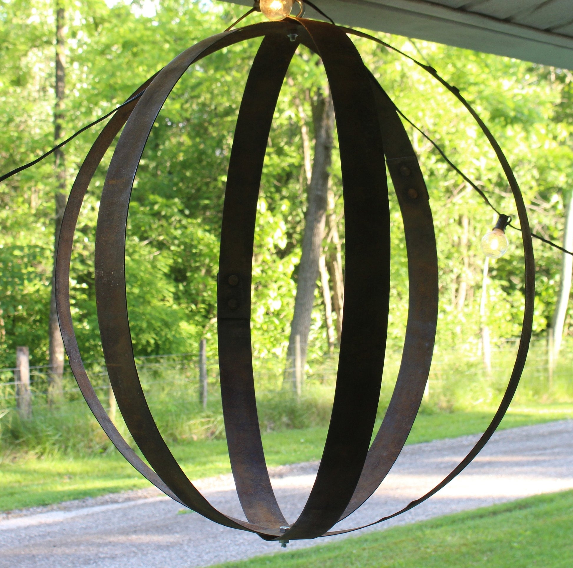 Rustic hanging plant holder made from reclaimed whiskey barrel rings, suitable for outdoor use, by AmishToyBox.com