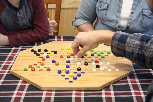 Hand-painted oak wooden Chinese checkers board game, 19-inch wide, with colorful geometric patterns and game pieces for family fun.