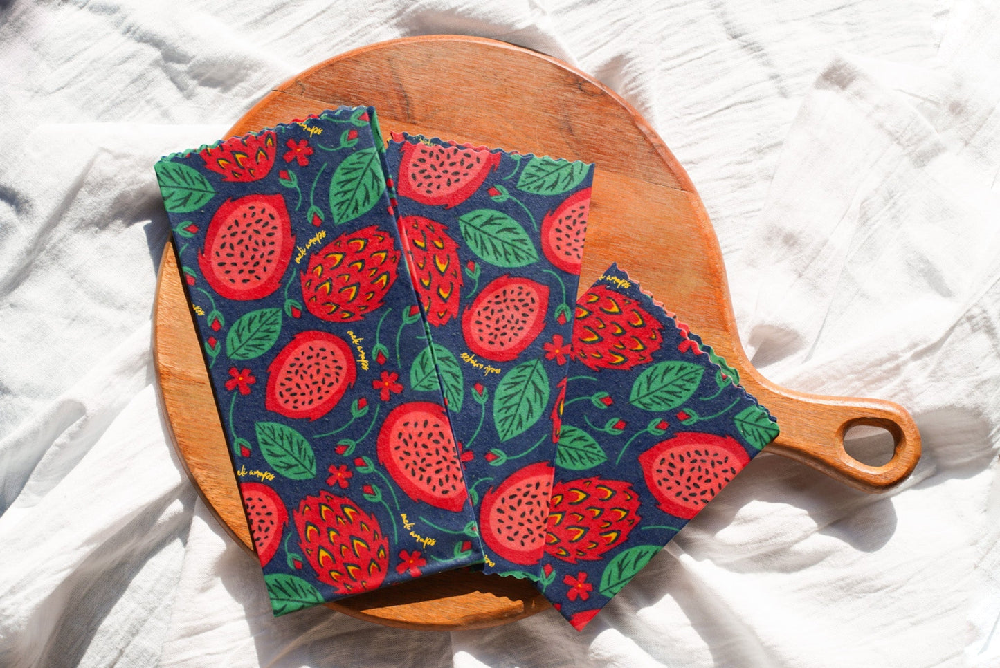 Meli Wraps beeswax wrap bulk roll with vibrant dragonfruit print, used for eco-friendly food wrapping and storage.