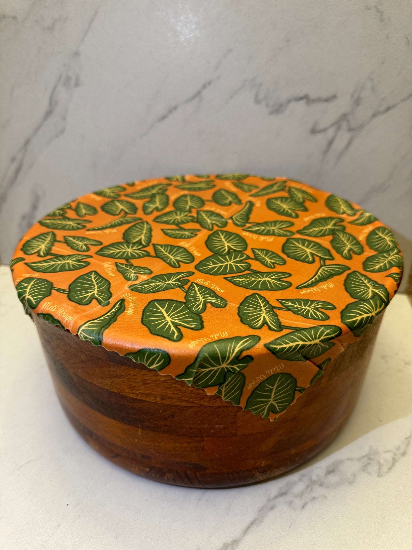 Meli Wraps beeswax roll in Kalo print, natural beeswax wrap bulk roll for reusable food storage, with colorful leaf pattern.