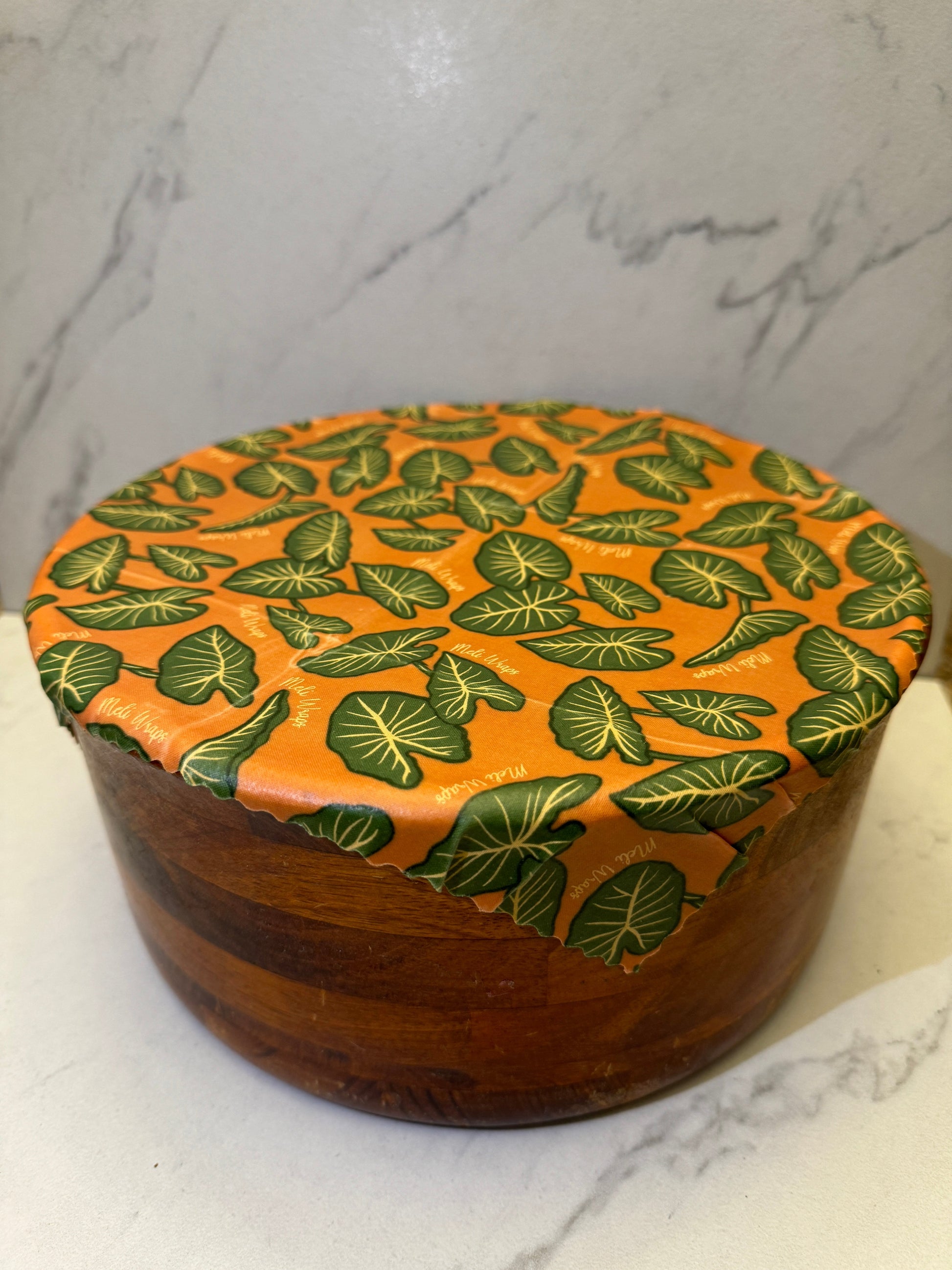 Meli Wraps beeswax roll in Kalo print, natural beeswax wrap bulk roll for reusable food storage, with colorful leaf pattern.