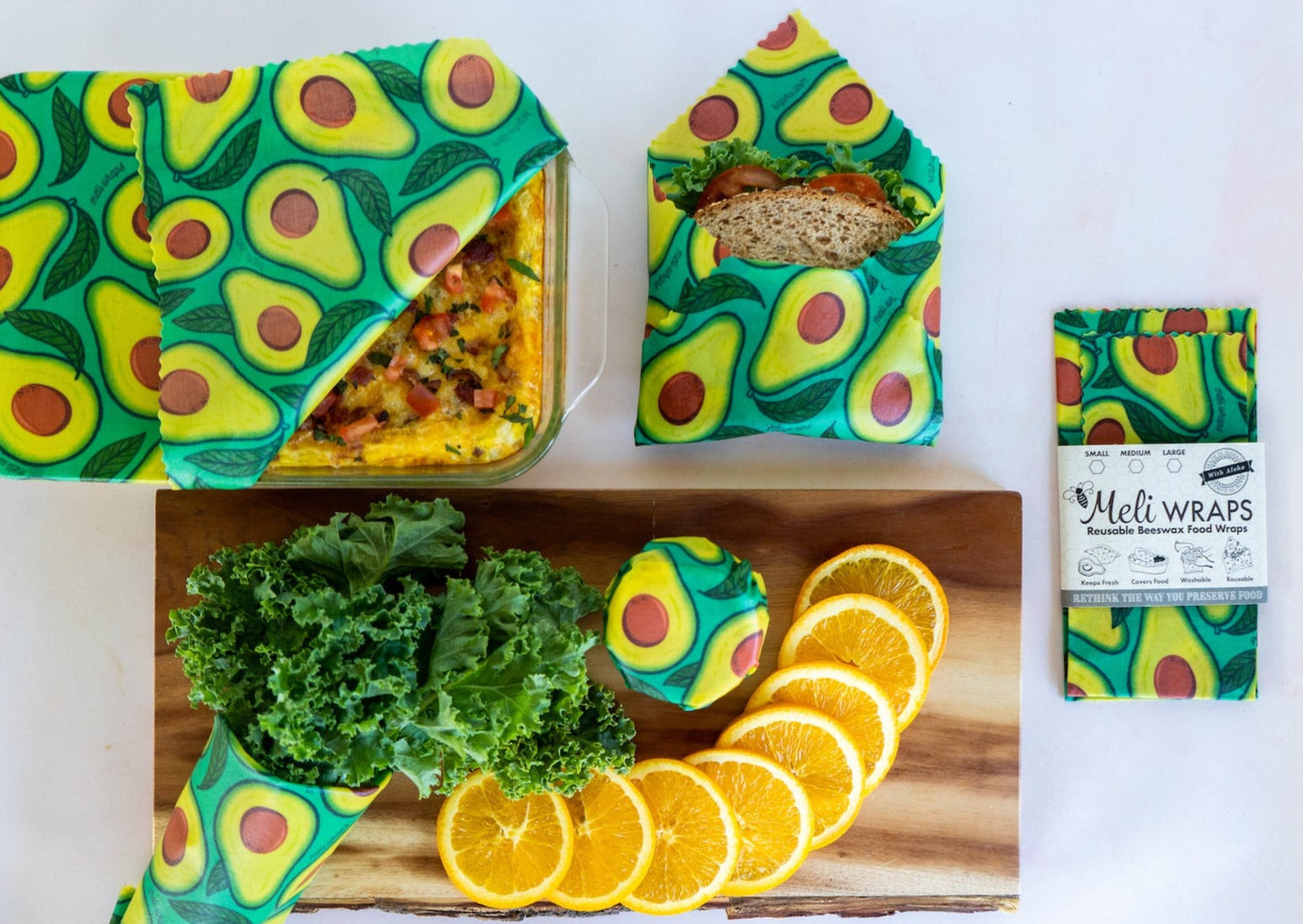 Set of three Meli Wraps beeswax food wraps with avocado print, available in small, medium, and large sizes for food storage.