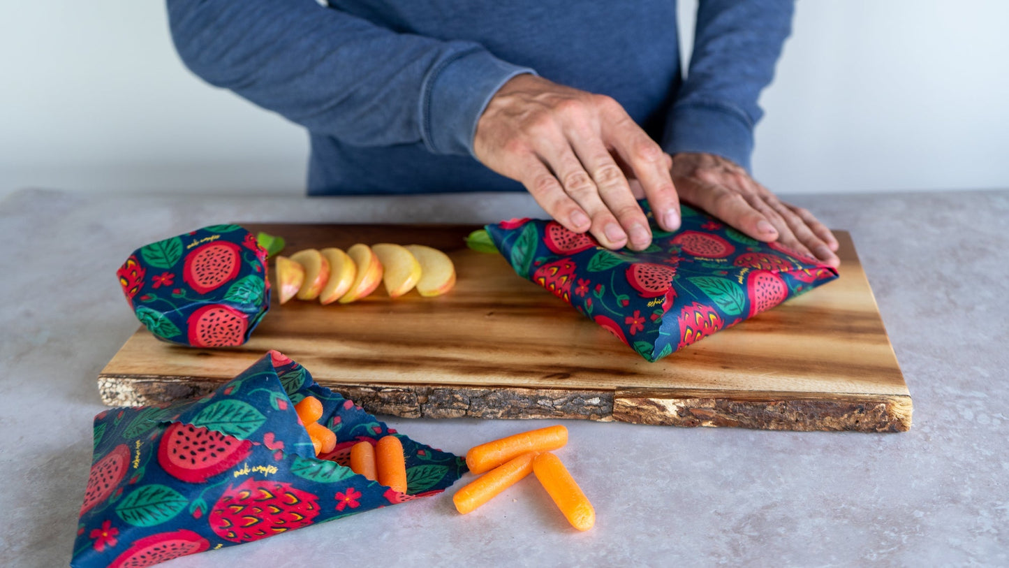 Set of three Meli Wraps beeswax food wraps with vibrant dragonfruit print in small, medium, and large sizes shown in the image.