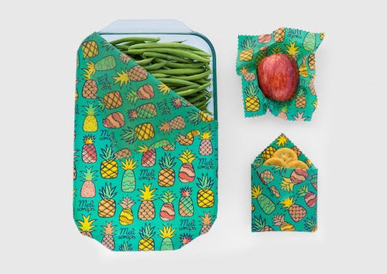 Set of three Meli Wraps beeswax food wraps with pineapple print in small, medium, and large sizes, featuring colorful tropical fruit designs.