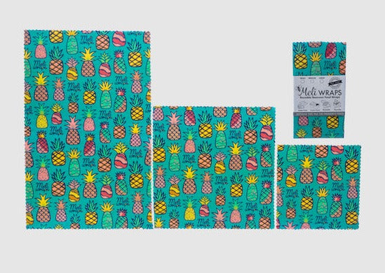 Set of Meli Wraps beeswax food wraps in pineapple print, including small, medium, and large sizes for food storage.