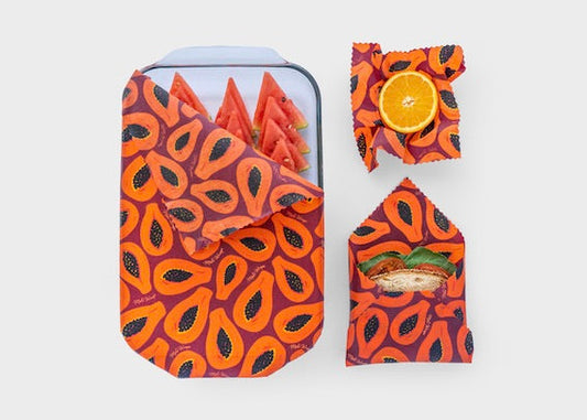 Set of Meli Wraps beeswax food wraps in purple papaya print, small, medium, and large sizes for eco-friendly food storage.