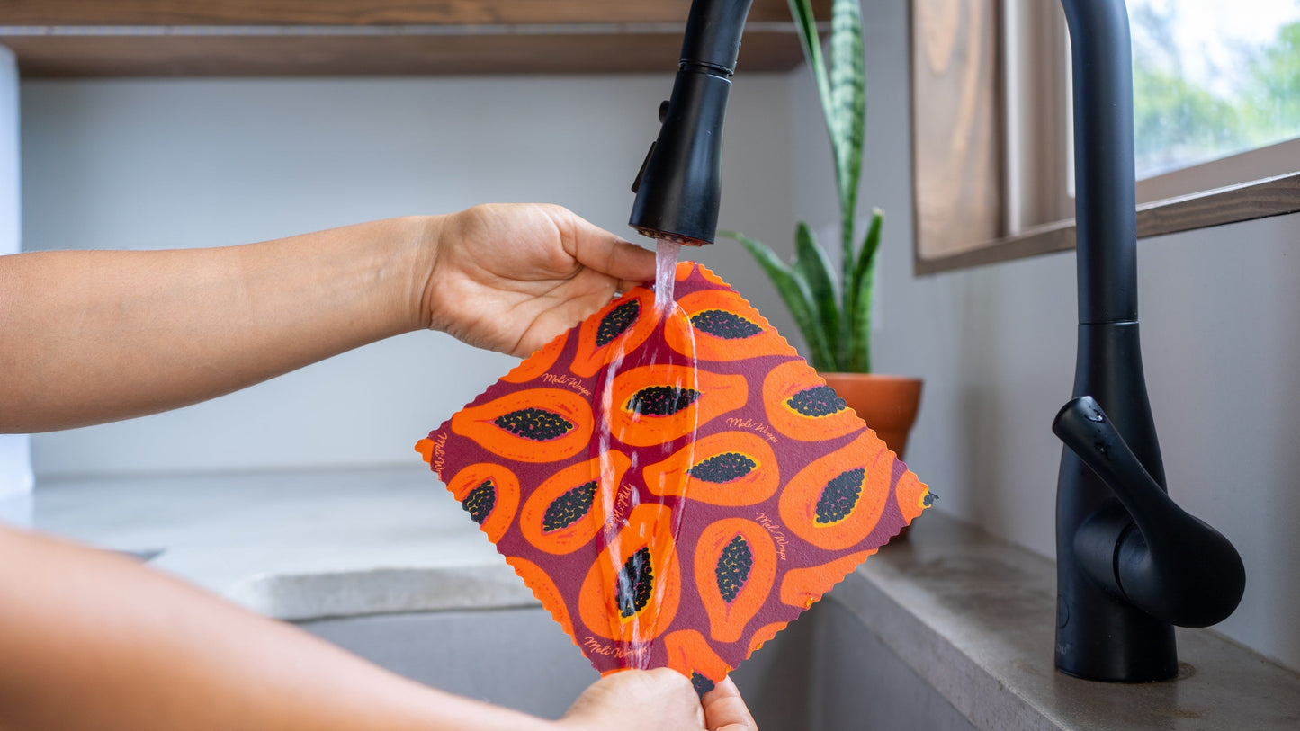 Set of three Meli Wraps beeswax food wraps in purple papaya print, reusable wraps for food storage in small, medium, and large sizes.
