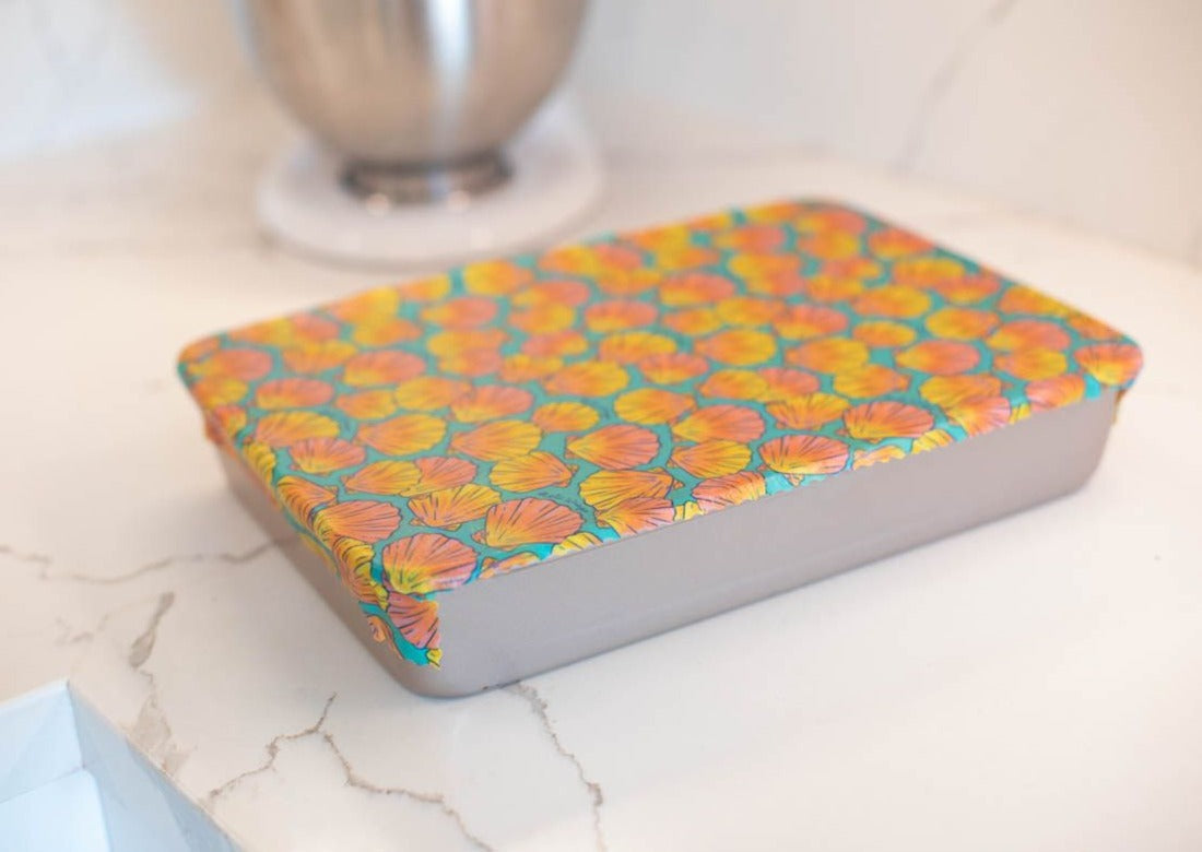 Set of Meli Wraps beeswax food wraps with sunrise shell print in small, medium, and large sizes, featuring vibrant ocean-inspired designs.