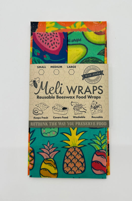 Set of four Meli Wraps beeswax wraps in fruit print, including small, medium, and large sizes for food wrapping.
