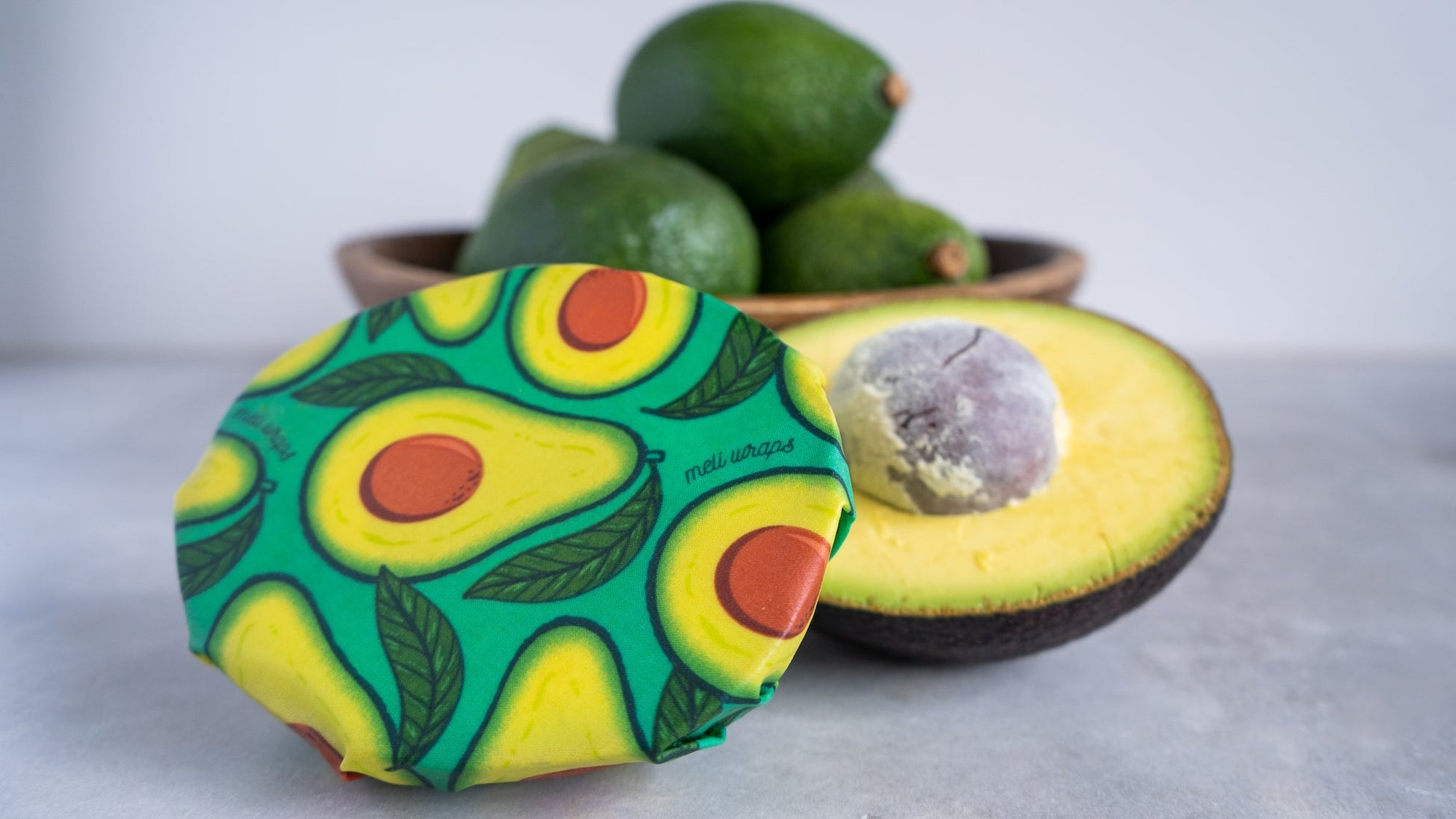 Set of four Meli Wraps beeswax wraps in fruit print, including small, medium, and large sizes for food storage and wrapping.