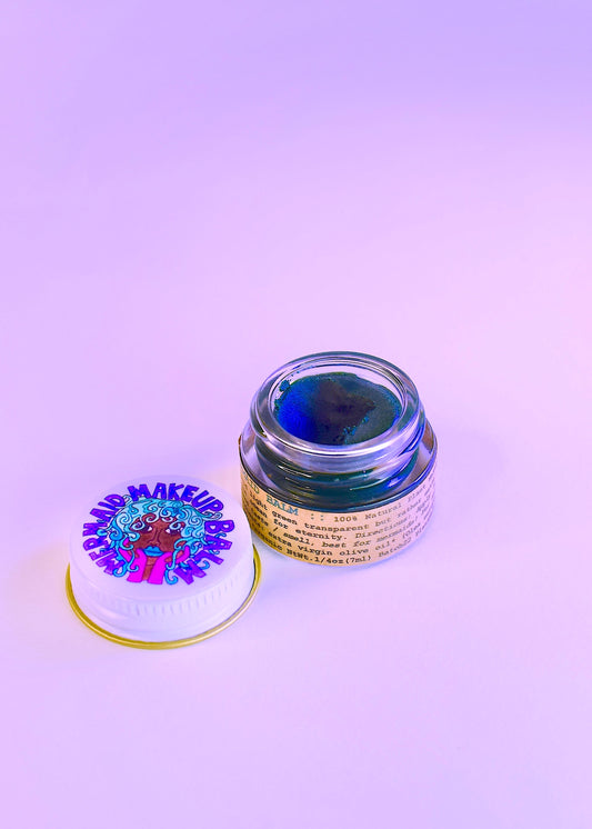 Plant Makeup Mermaid Makeup Balm in a colorful, iridescent container with a shimmering, mermaid-inspired design.