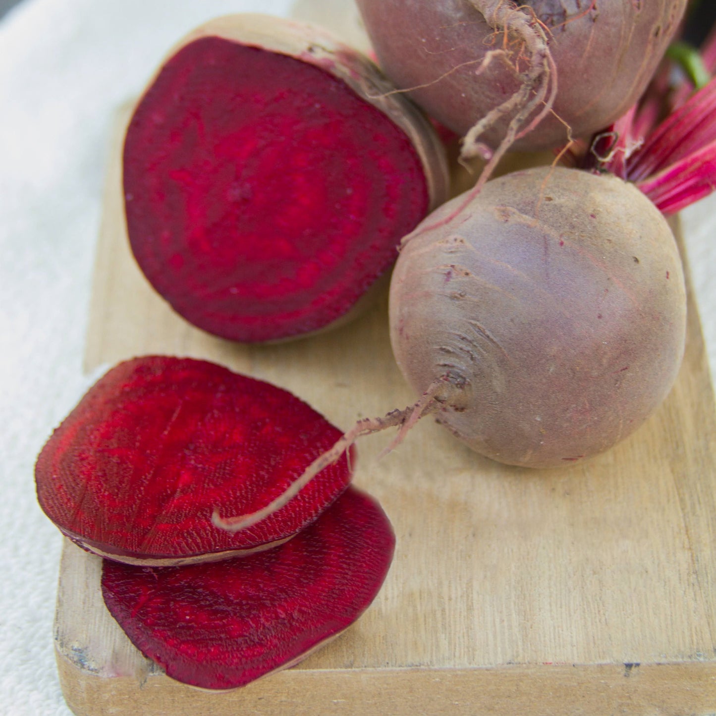 Early Wonder Tall Top Beet by MIgardener, fresh beet with vibrant green leaves and deep red root, ready for harvest.
