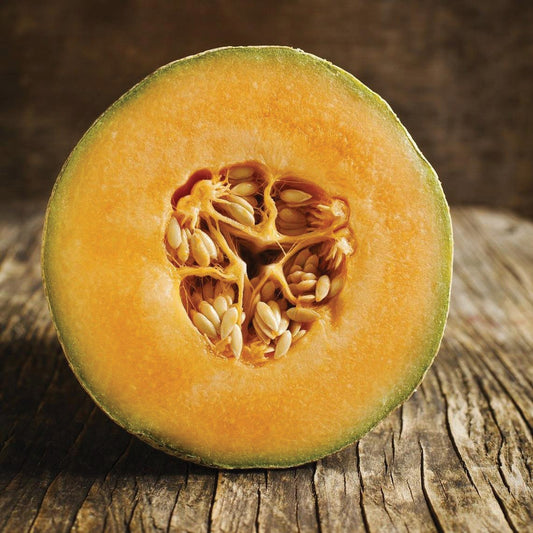 Honey Rock melon from MIgardener, showing the ripe, orange-fleshed melon with smooth green rind.