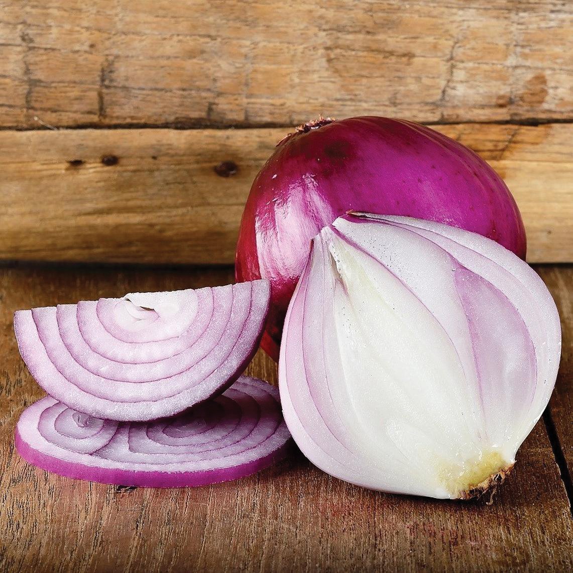 Red Burgundy Onion from MIgardener, showing a close-up of fresh, vibrant red onion with layered skin and green shoots.