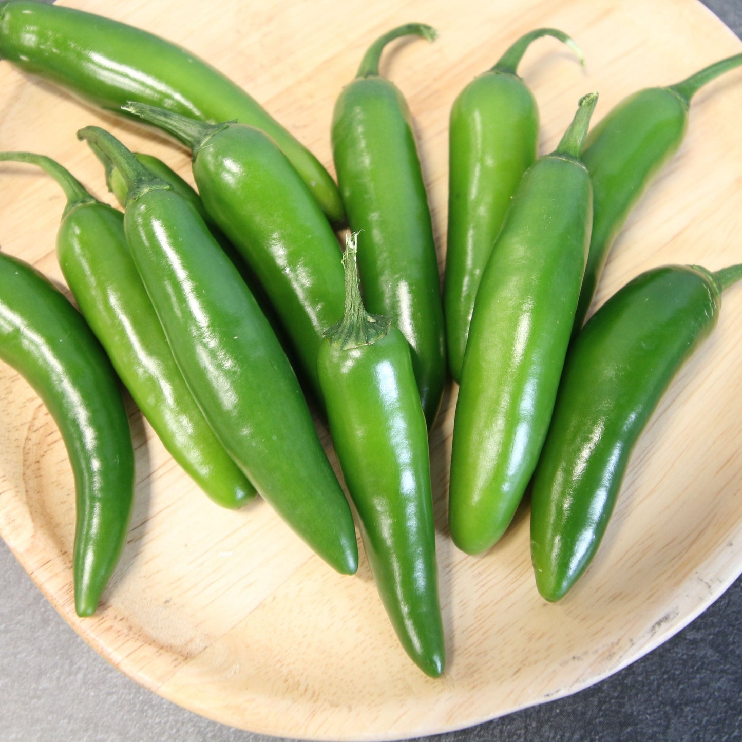 Fresh Serrano Tampiqueño pepper from MIgardener, vibrant green and medium-sized with a smooth, shiny surface.