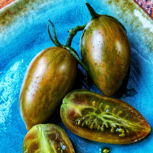 Healthy Lucky Tiger tomato from MIgardener, ripe and red with green stems, ready for harvest.