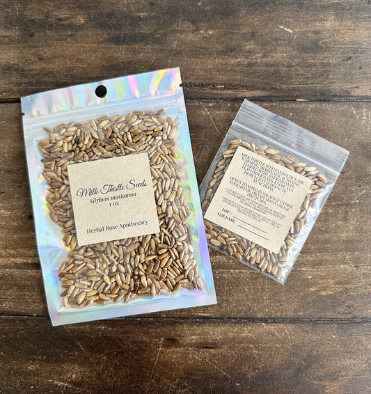 Dried Milk Thistle Seeds in a labeled package from HerbalRoseApothecary, showcasing the herbal supplement's natural seed form.