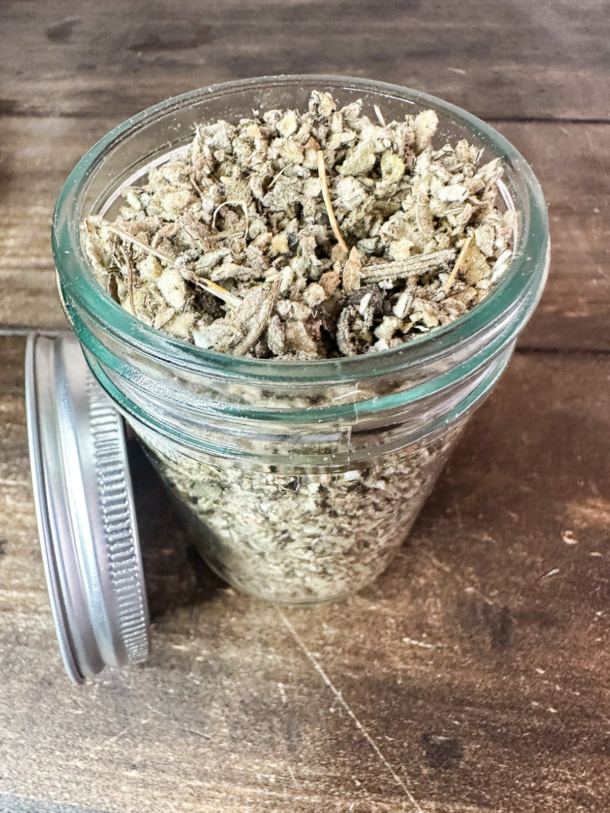 Small jar of dried mullein herbs in a herbalroseapothecary herb jar, showcasing herbal dried plant leaves.