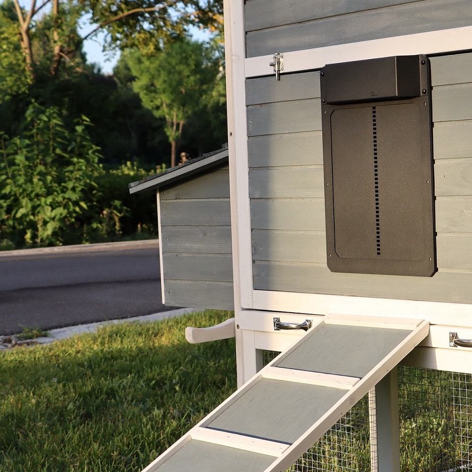 Farmight automatic chicken coop door made of aluminum, designed for easy access and security for poultry in a backyard coop.